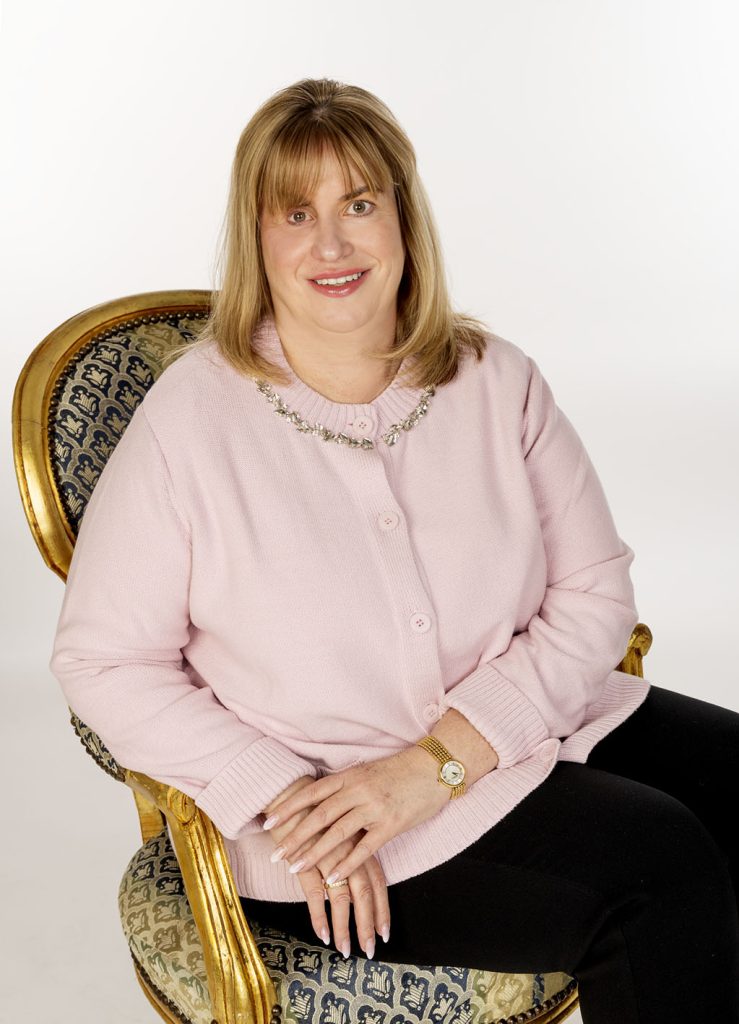 Frau in rosa Strickjacke sitzt